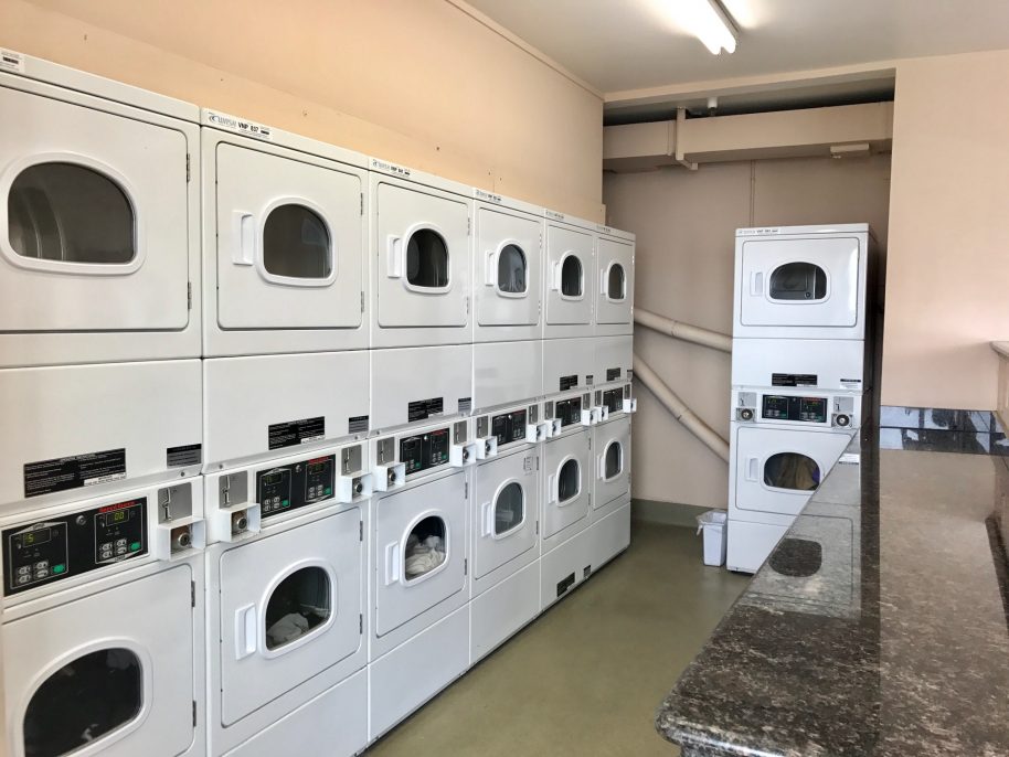 The laundry room is spacious with machines kept in good working order.
