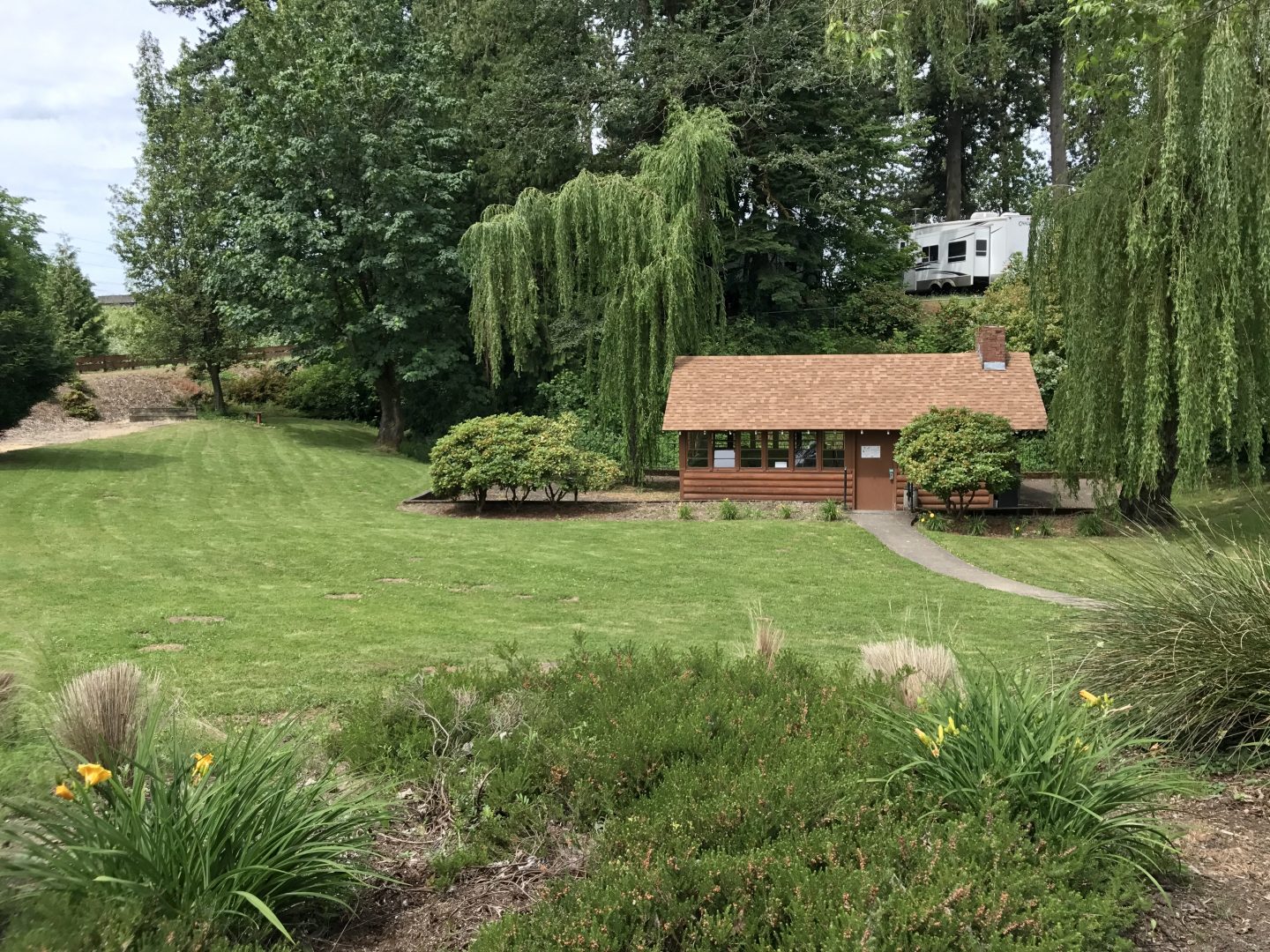 This large common area features a small waterfall and stream alongside picnic tables and grills. 