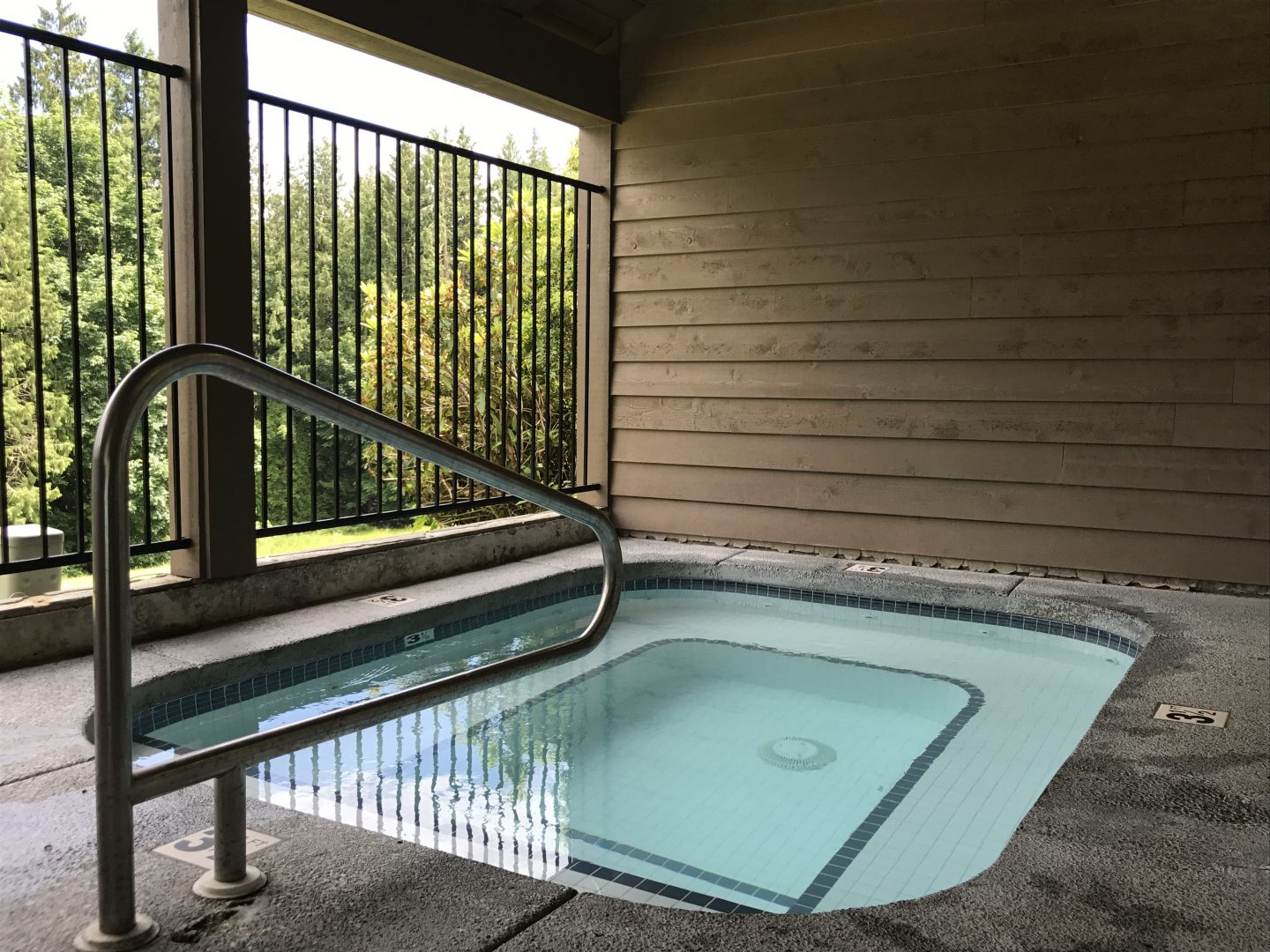 The spa overlooks a natural area and is set aside from the pool deck just enough to make it a little more quiet and relaxing.