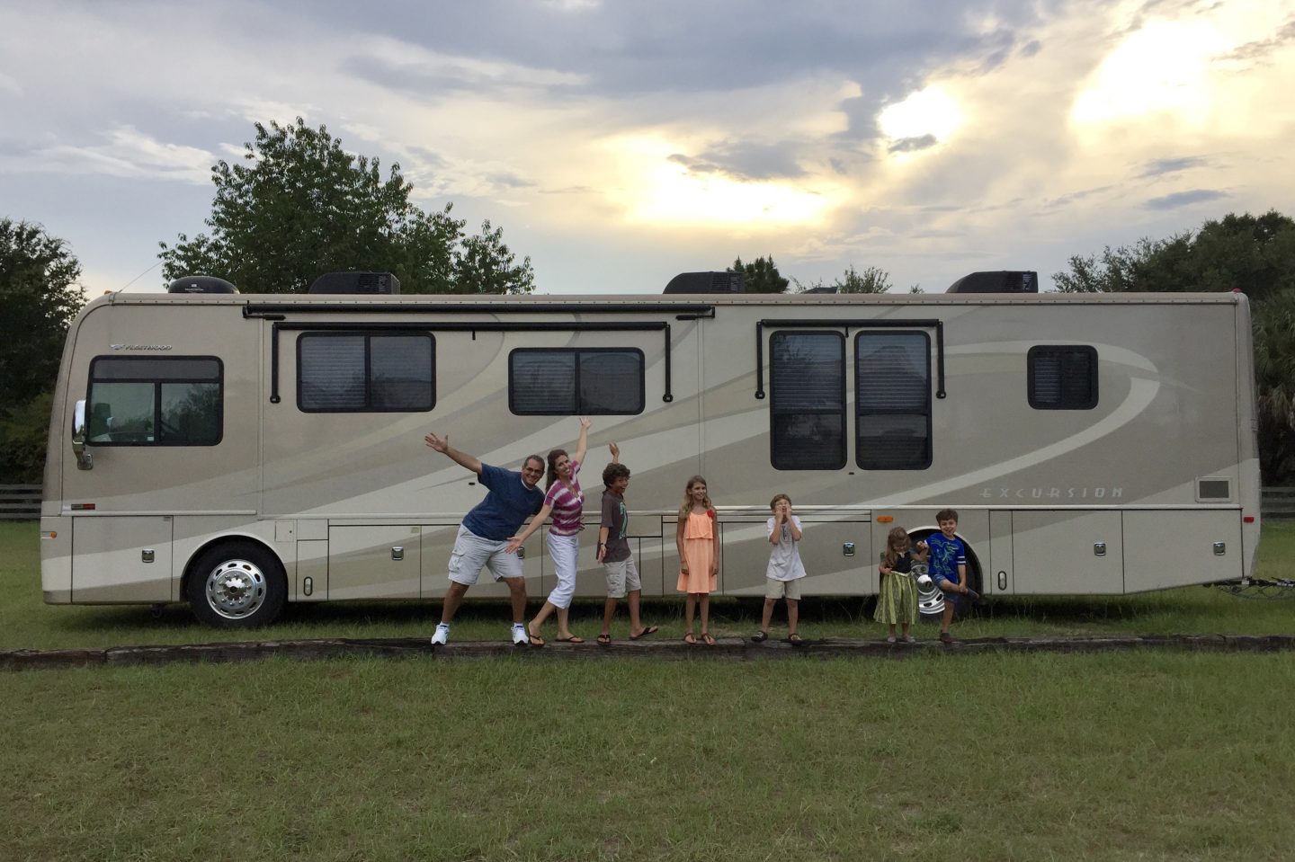 Our goofy family in front of our home on wheels.